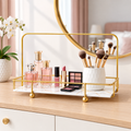 Golden Arc Vanity Stand styled with perfume bottles and makeup brushes on a dresser