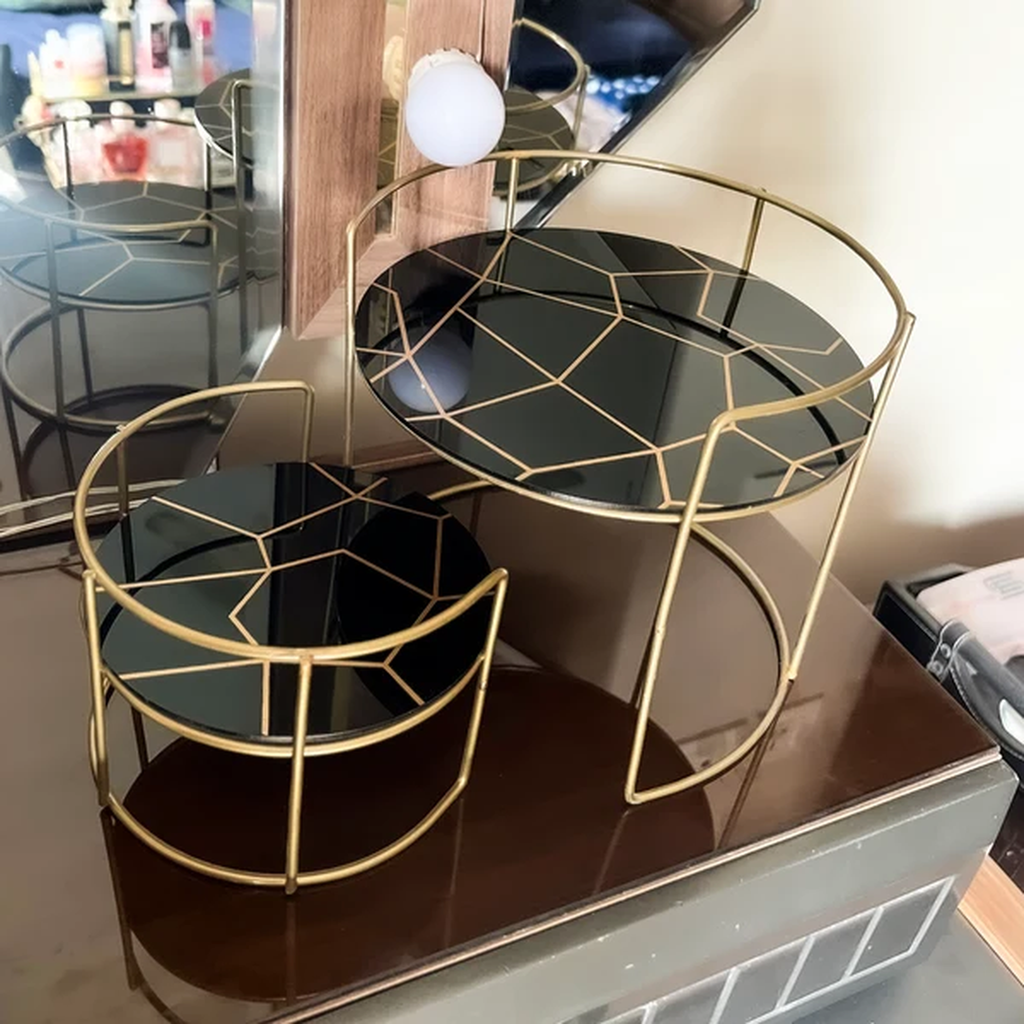 Round Marble Vanity Stands in black marble on a dresser