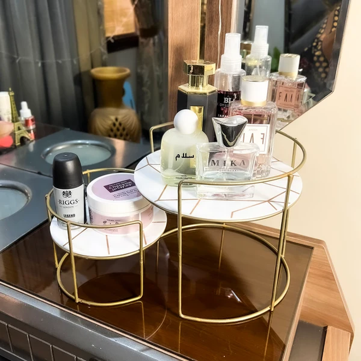 Round Marble Vanity Stands in white marble on a dresser with perfumes
